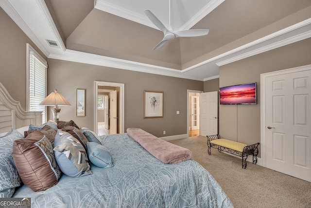bedroom featuring ornamental molding, carpet floors, a raised ceiling, and visible vents