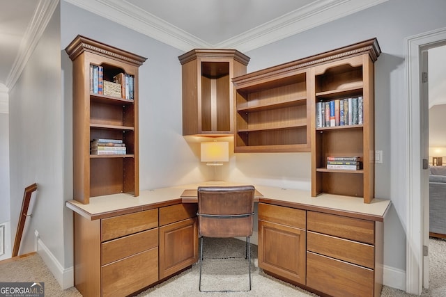 office area featuring light colored carpet, built in study area, ornamental molding, and baseboards