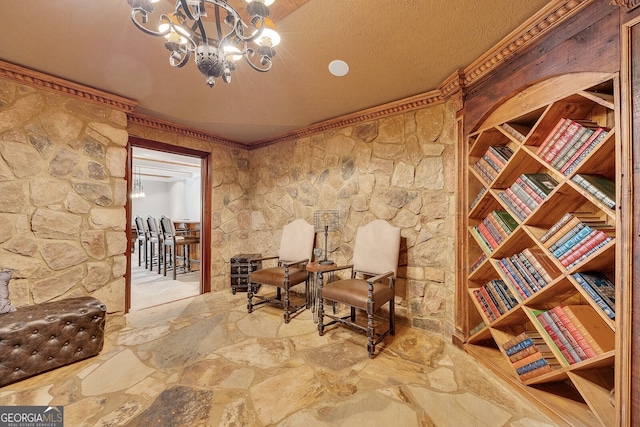 sitting room with crown molding, an inviting chandelier, and a textured ceiling
