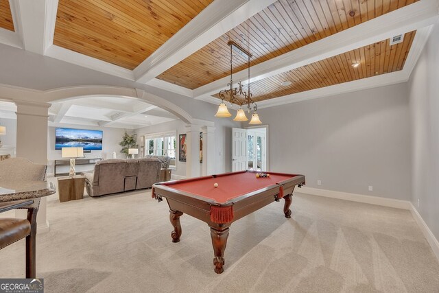 game room featuring beamed ceiling, ornate columns, arched walkways, carpet floors, and coffered ceiling