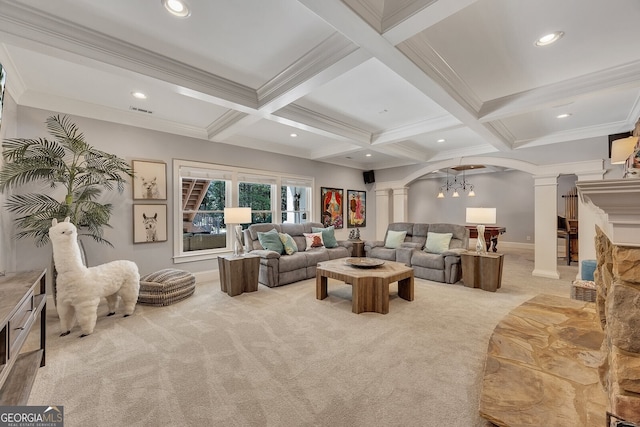 living area with ornate columns, beam ceiling, coffered ceiling, arched walkways, and light colored carpet