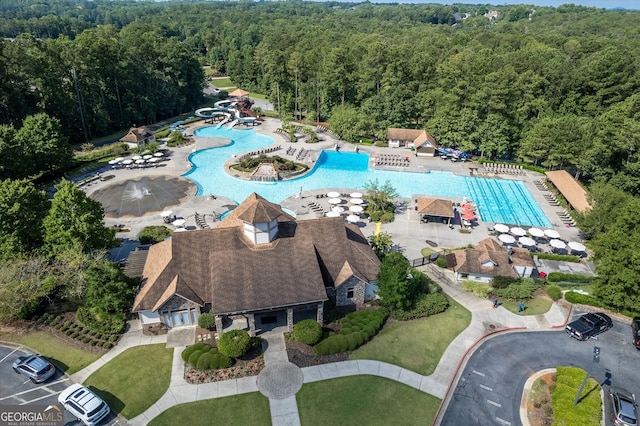 bird's eye view with a wooded view
