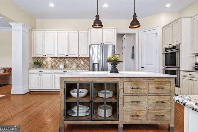 2358 New Salem Trce, Marietta, GA 30064 - kitchen with appliances with stainless steel finishes, ornate columns, tasteful backsplash, dark wood finished floors, and decorative light fixtures