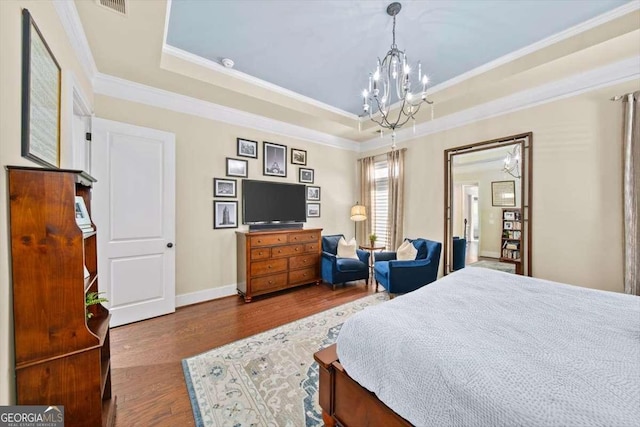 2358 New Salem Trce, Marietta, GA 30064 - bedroom featuring a chandelier, a tray ceiling, wood finished floors, and ornamental molding