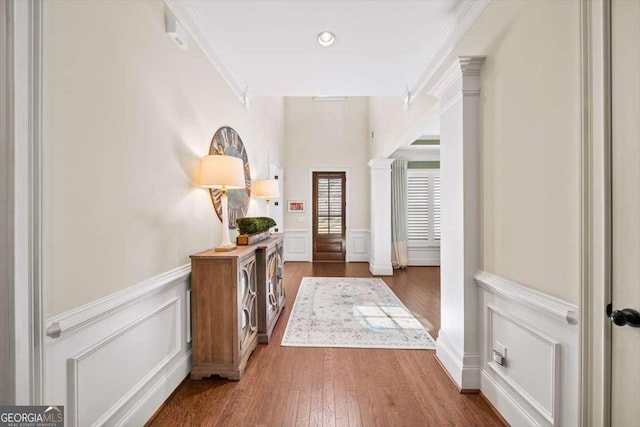 2358 New Salem Trce, Marietta, GA 30064 - foyer with crown molding, wainscoting, wood finished floors, a decorative wall, and ornate columns