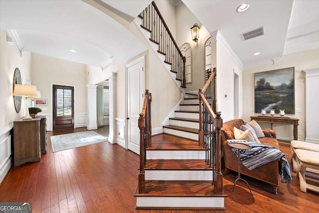 2358 New Salem Trce, Marietta, GA 30064 - foyer featuring hardwood / wood-style flooring, stairs, a wainscoted wall, arched walkways, and a decorative wall