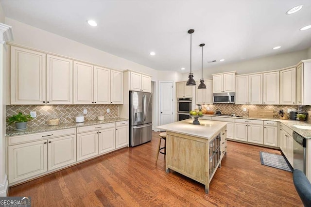 2358 New Salem Trce, Marietta, GA 30064 - kitchen with stainless steel appliances, tasteful backsplash, a center island, a breakfast bar, and pendant lighting