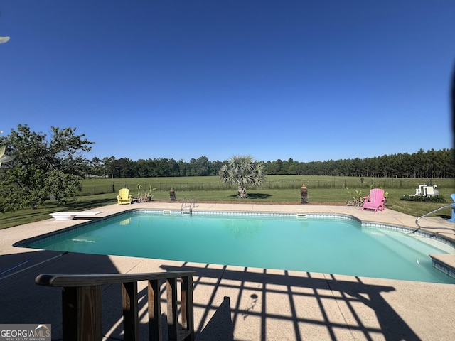 view of pool featuring a patio area, a fenced in pool, fence, and a lawn