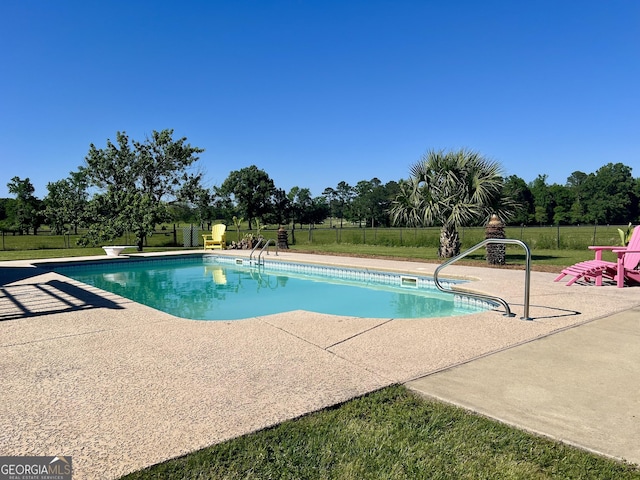view of pool with a fenced in pool, a patio area, a yard, and fence