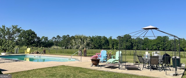 view of swimming pool with a fenced in pool, a patio, a yard, and fence