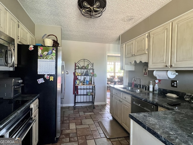 kitchen featuring wall oven, stainless steel microwave, a sink, dark countertops, and a toaster