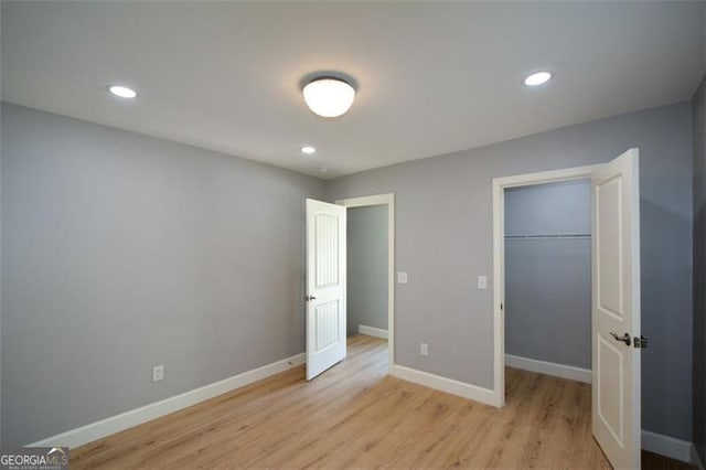 unfurnished bedroom with baseboards, light wood-style floors, and recessed lighting