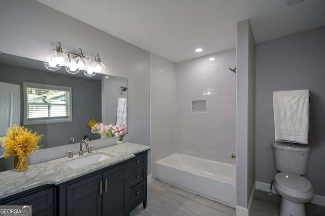 bathroom featuring toilet, baseboards, recessed lighting, washtub / shower combination, and vanity