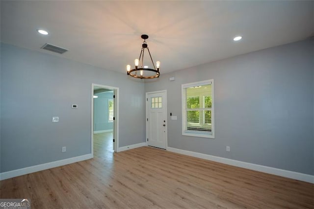 interior space with visible vents, baseboards, a notable chandelier, light wood-style floors, and recessed lighting