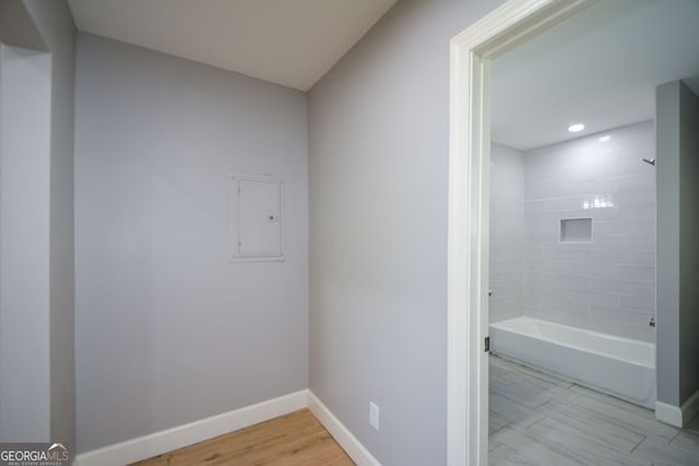 full bathroom featuring recessed lighting, wood finished floors, baseboards, and shower / washtub combination