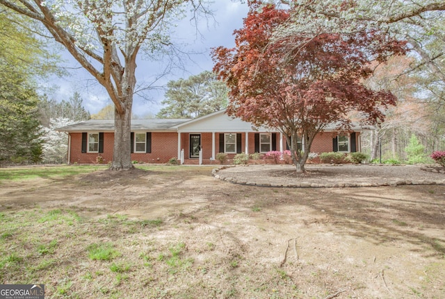 single story home with brick siding and a porch