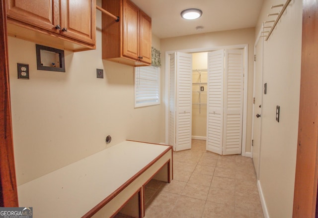 corridor featuring baseboards and light tile patterned flooring