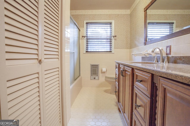 724 Ga Highway 120, Tallapoosa, GA 30176 - bathroom featuring wallpapered walls, vanity, wainscoting, heating unit, and enclosed tub / shower combo