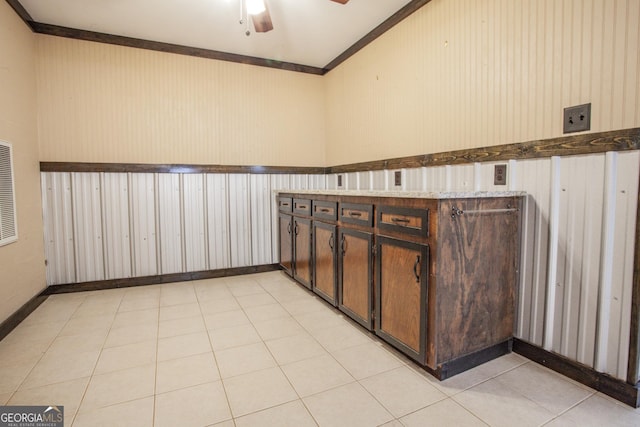 interior space with ornamental molding and ceiling fan