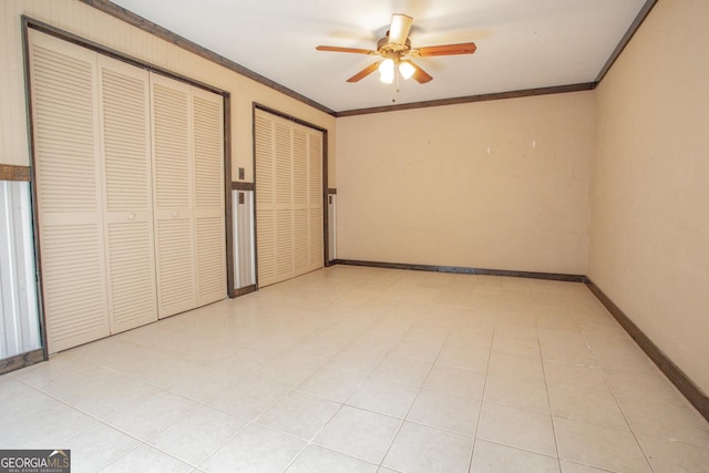724 Ga Highway 120, Tallapoosa, GA 30176 - unfurnished bedroom featuring crown molding, ceiling fan, two closets, and light tile patterned floors