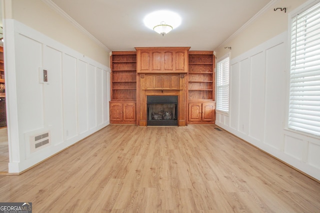 724 Ga Highway 120, Tallapoosa, GA 30176 - unfurnished living room featuring a decorative wall, a fireplace, light wood-type flooring, plenty of natural light, and ornamental molding