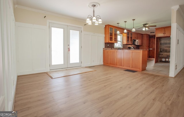 724 Ga Highway 120, Tallapoosa, GA 30176 - kitchen with a peninsula, glass insert cabinets, open floor plan, light wood-style floors, and a decorative wall
