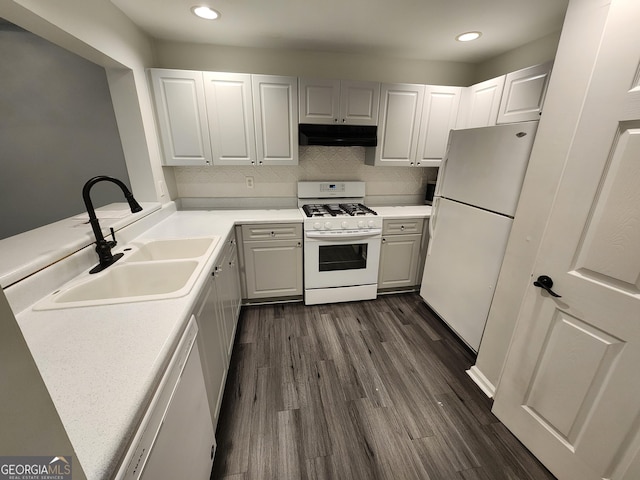 220 Renaissance Pkwy NE Apt 2220, Atlanta, GA 30308 - kitchen featuring white appliances, under cabinet range hood, a sink, dark wood-style flooring, and light countertops