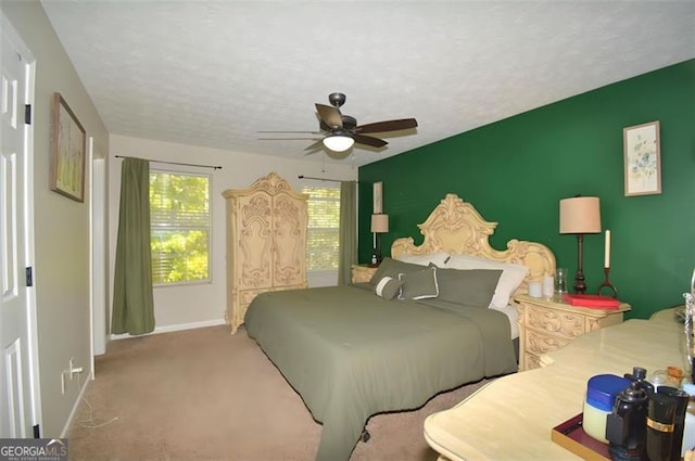 carpeted bedroom with baseboards and ceiling fan