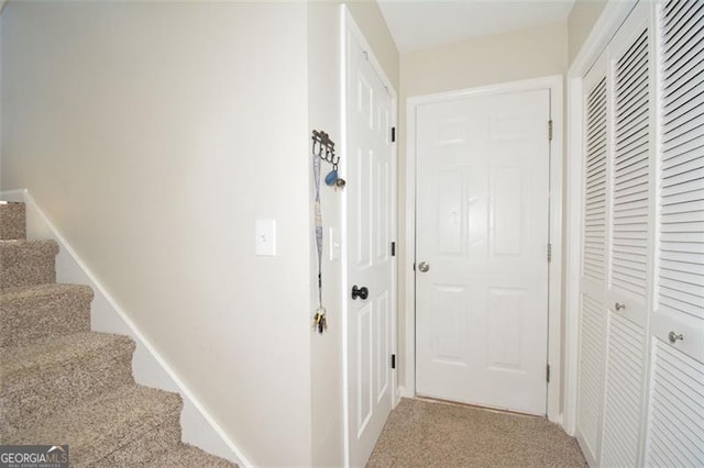 hallway with stairs and carpet floors