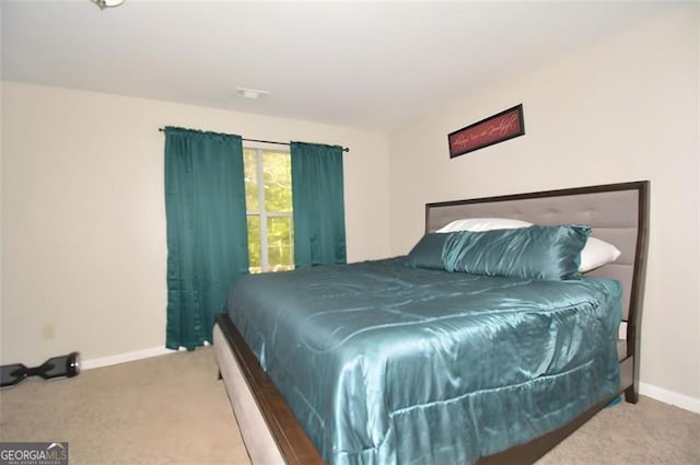 carpeted bedroom featuring baseboards and visible vents