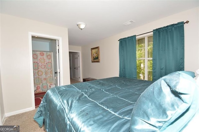 carpeted bedroom with visible vents and baseboards