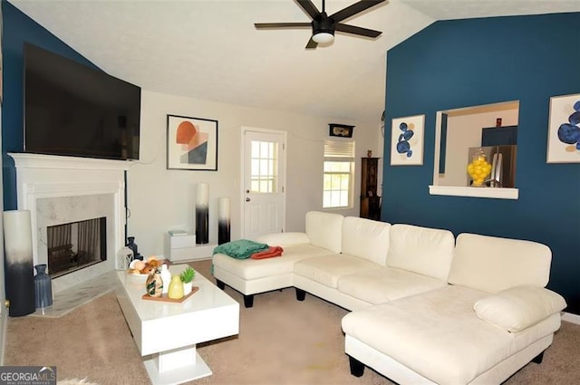 living room with ceiling fan, carpet, a fireplace, and lofted ceiling