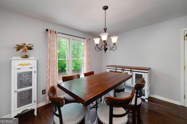 dining room featuring an inviting chandelier, dark wood finished floors, and baseboards