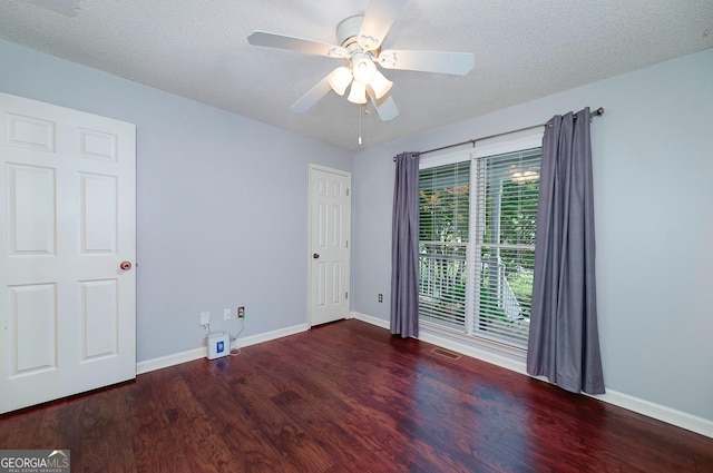 spare room with a ceiling fan, baseboards, visible vents, and wood finished floors
