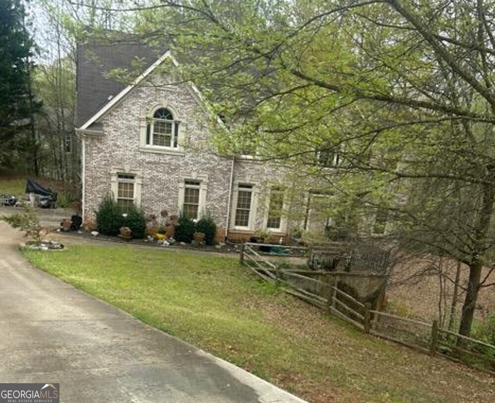 4588 Carissa Ct, Ellenwood, GA 30294 - view of front of home featuring a front yard and fence