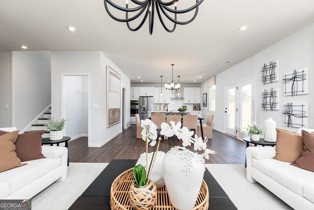 living area with a chandelier, stairway, dark wood-type flooring, and recessed lighting