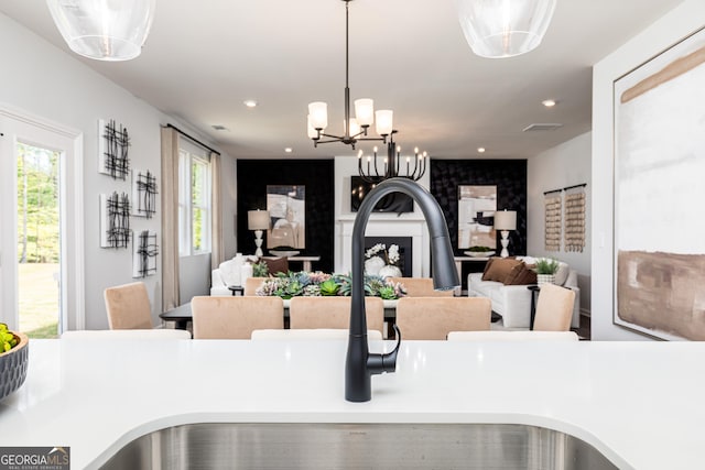 interior details featuring a sink, visible vents, recessed lighting, a chandelier, and hanging light fixtures