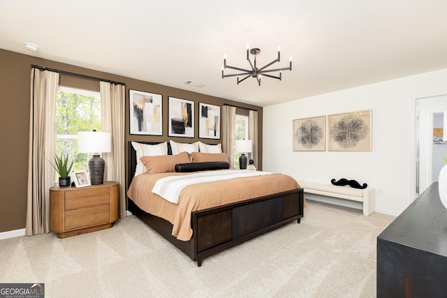 bedroom featuring a notable chandelier, visible vents, baseboards, and light carpet