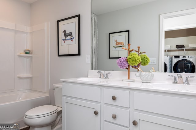 full bathroom with double vanity, toilet, a sink, and washer and clothes dryer