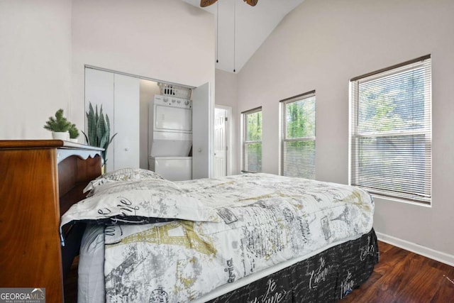 3690 Asbury Ln SW, Atlanta, GA 30331 - bedroom featuring stacked washer / dryer, wood finished floors, a closet, high vaulted ceiling, and ceiling fan