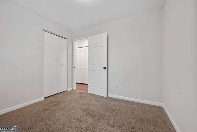 3690 Asbury Ln SW, Atlanta, GA 30331 - unfurnished bedroom with carpet flooring and a closet