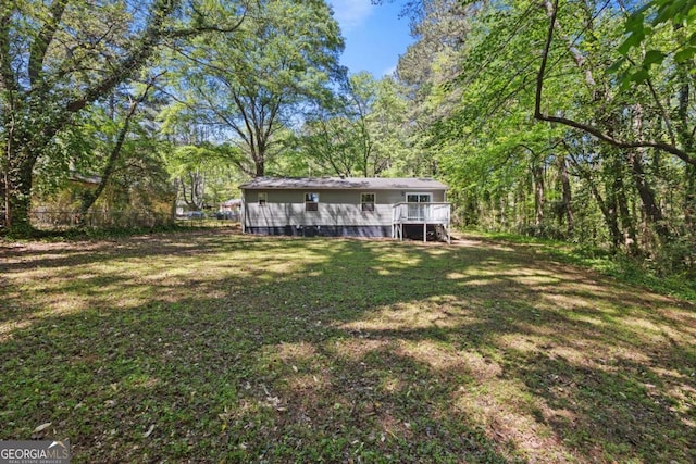 3690 Asbury Ln SW, Atlanta, GA 30331 - view of yard with a deck and a view of trees