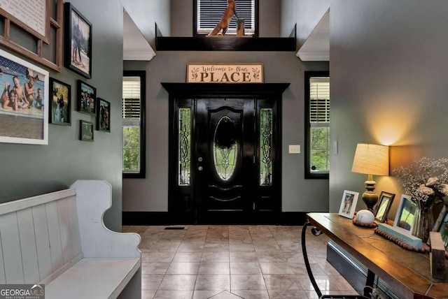 1055 River Bluff Dr, Winder, GA 30680 - foyer entrance featuring crown molding, baseboards, and a high ceiling