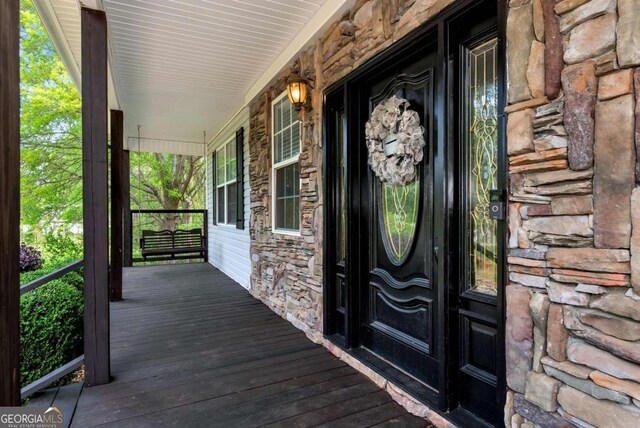 1055 River Bluff Dr, Winder, GA 30680 - view of exterior entry with a porch and stone siding