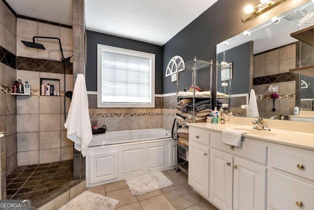 1055 River Bluff Dr, Winder, GA 30680 - bathroom featuring a bath, a walk in shower, tile patterned flooring, and tile walls