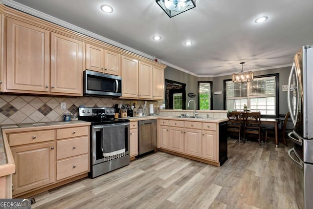 1055 River Bluff Dr, Winder, GA 30680 - kitchen with a chandelier, a peninsula, appliances with stainless steel finishes, and light brown cabinets