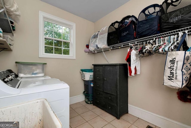 1055 River Bluff Dr, Winder, GA 30680 - clothes washing area with independent washer and dryer, laundry area, light tile patterned floors, and baseboards
