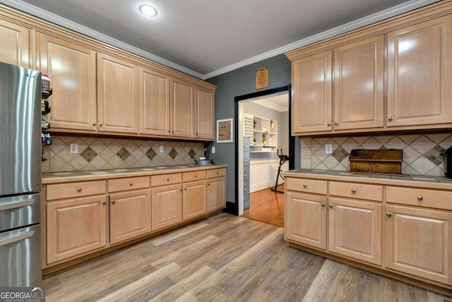 1055 River Bluff Dr, Winder, GA 30680 - kitchen with freestanding refrigerator, light brown cabinetry, and backsplash