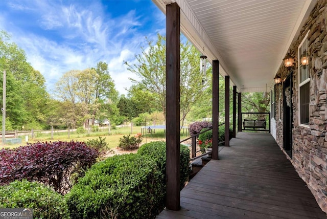 1055 River Bluff Dr, Winder, GA 30680 - deck with a trampoline and covered porch