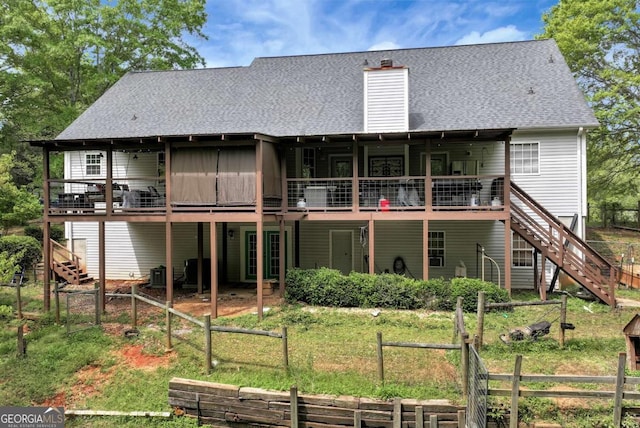 1055 River Bluff Dr, Winder, GA 30680 - rear view of house featuring roof with shingles, a wooden deck, and stairway
